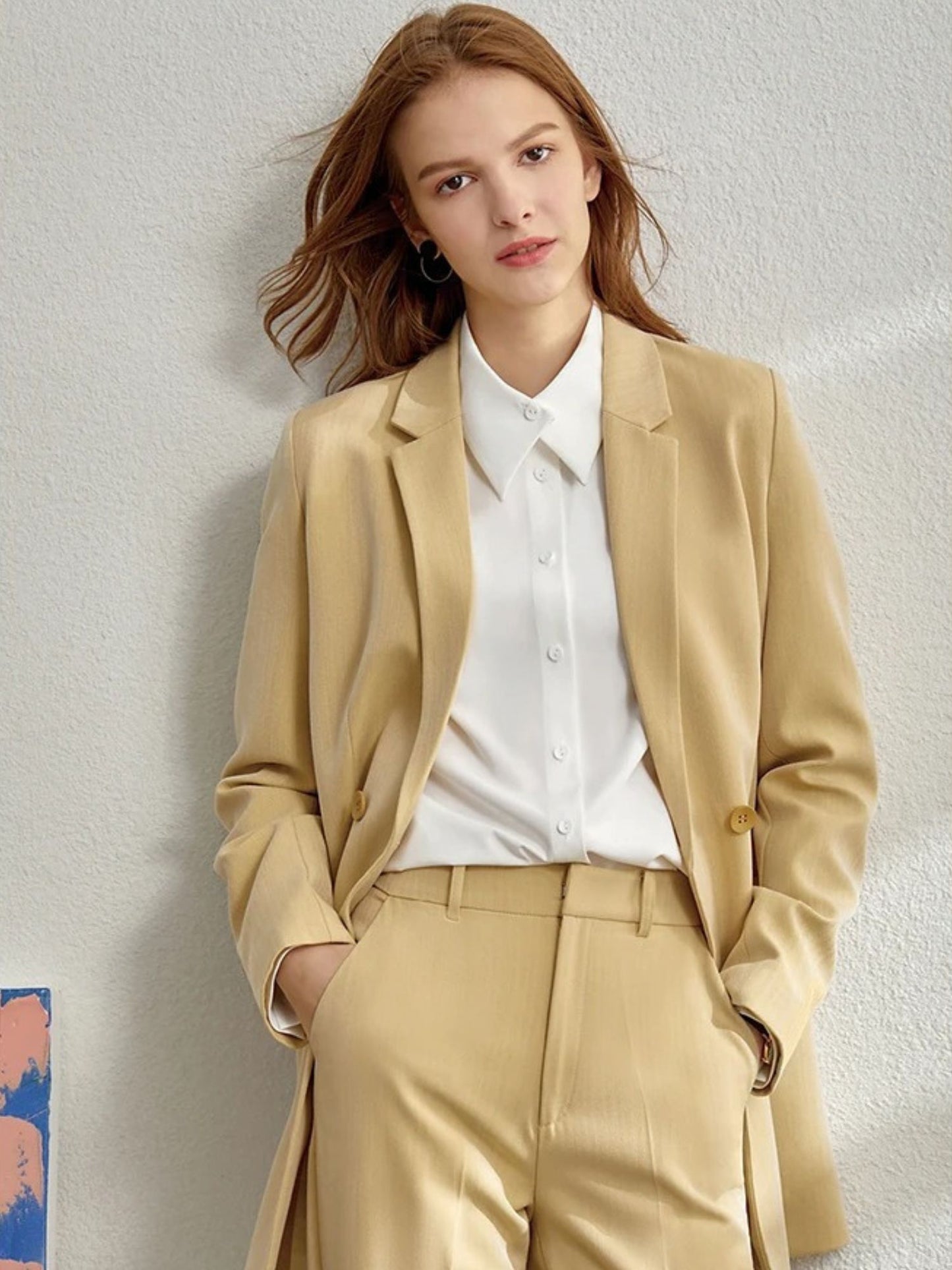 Camel pantsuit with soft tailoring, white blouse, and matching jacket draped open