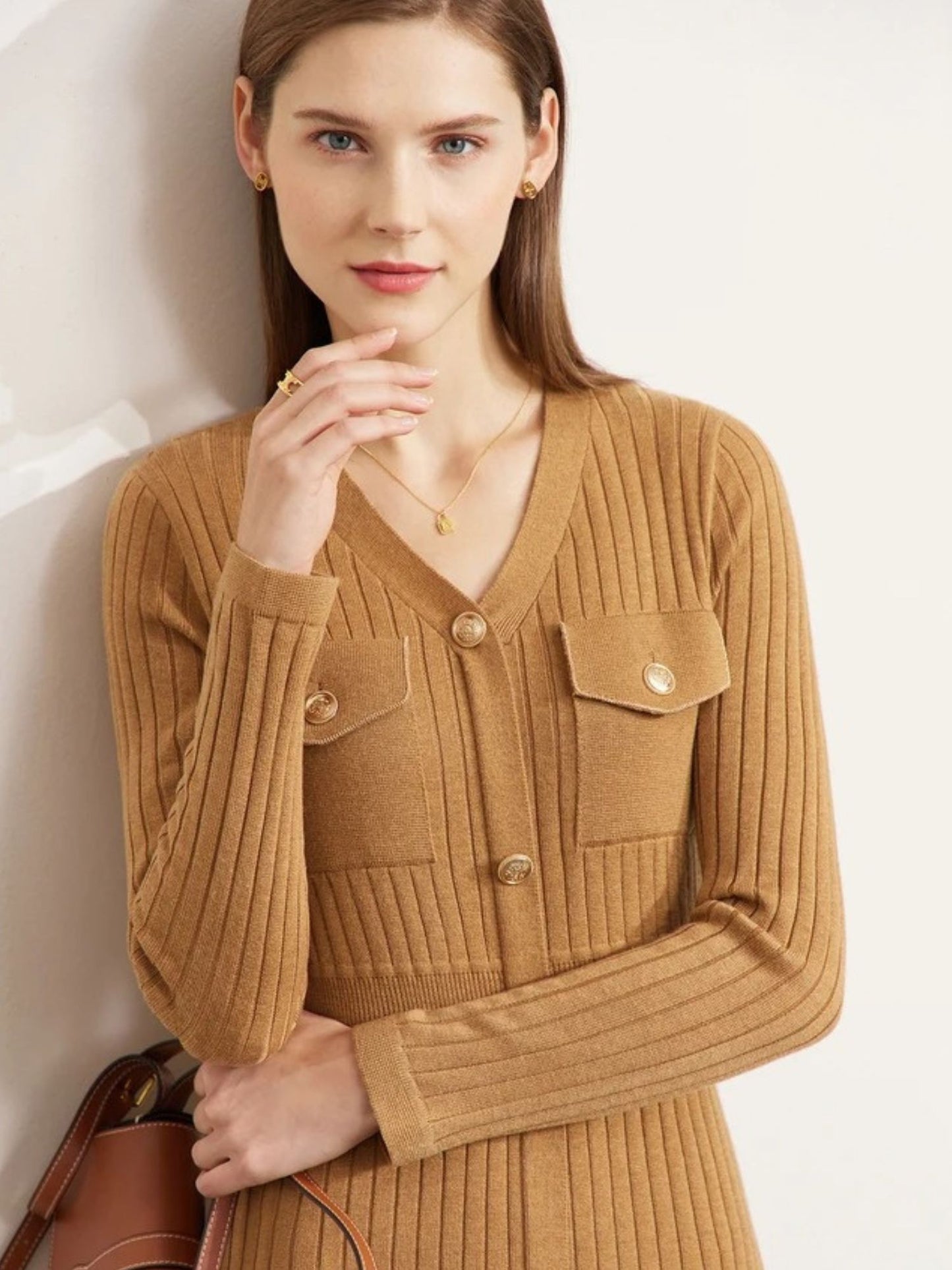 Close-up of camel ribbed dress with pointed collar and gold buttons