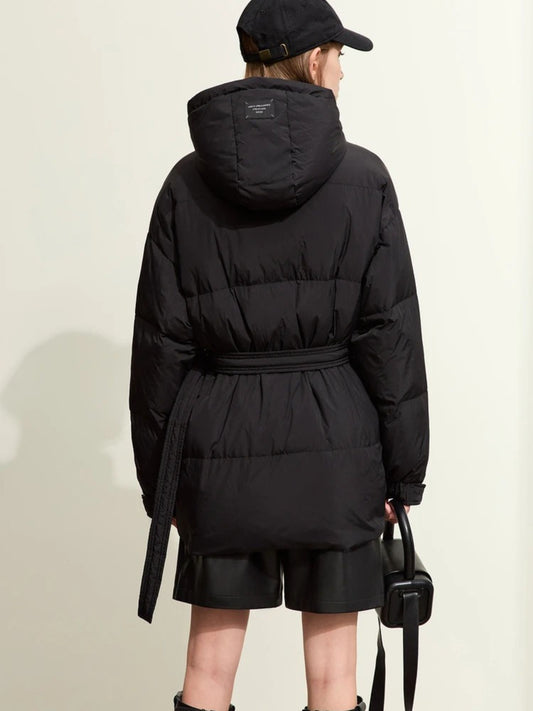 Back view of short black puffer jacket with belted waist and hood detail