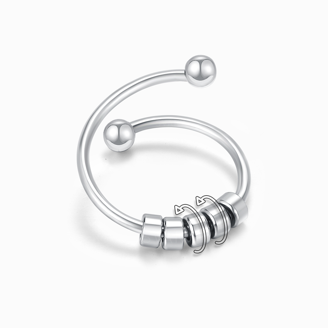 Silver ring with beads on a white background