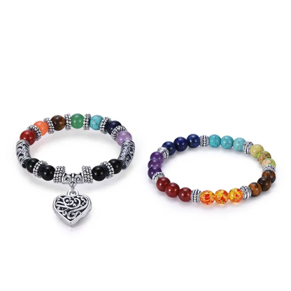 Colorful beaded bracelets with a heart pendant on a white background.