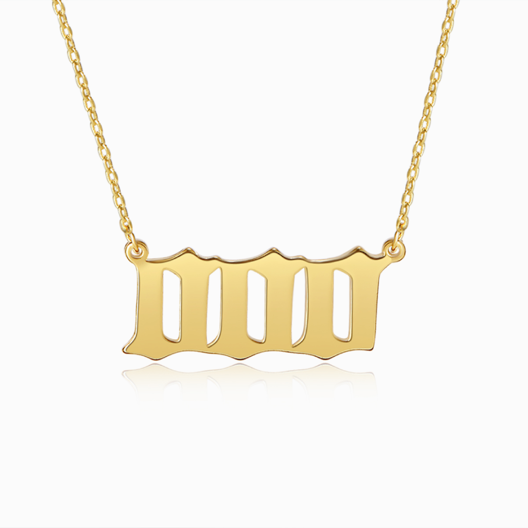 Gold chain necklace with three gold zero digits on a white background