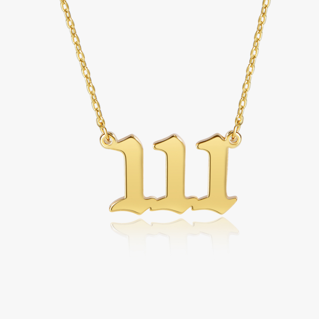 Gold chain with gold angel number 111 pendant on white background