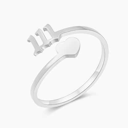 Silver ring with angel number 111 and heart charm on a white background