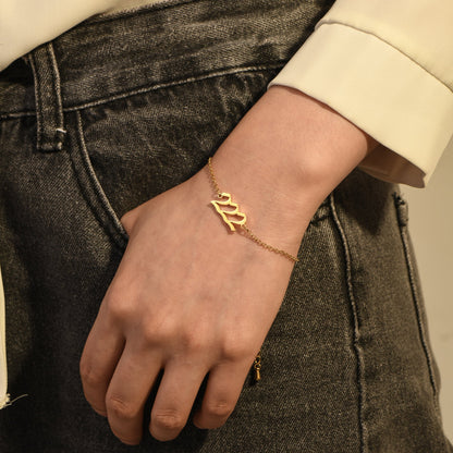 Gold angel number 222 bracelet on a woman's wrist