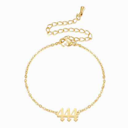 Gold bracelet with angel number 444 on a white background.