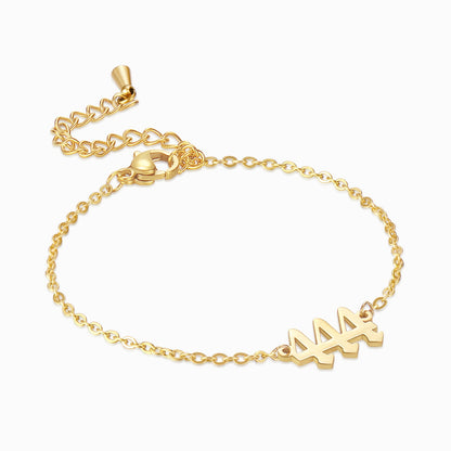 A gold bracelet with angel number 444 on a white background.