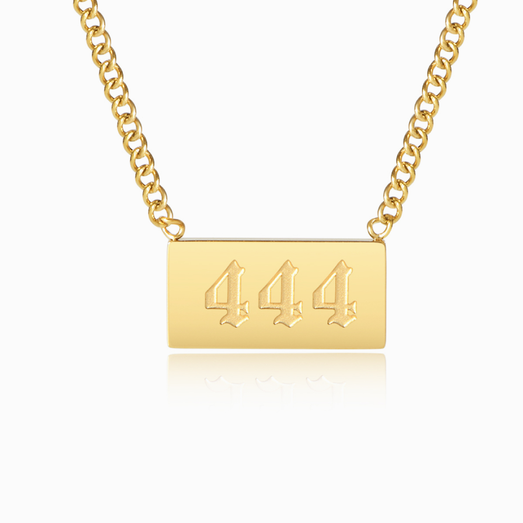 Gold necklace with angel number 444 pendant on a white background