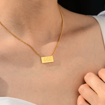 A woman wearing a gold necklace with angel number 444 pendant