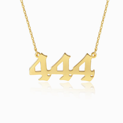 Gold necklace with angel number 444 pendant on a white background