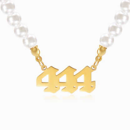 Gold necklace with angel number 444 pendant on a white background