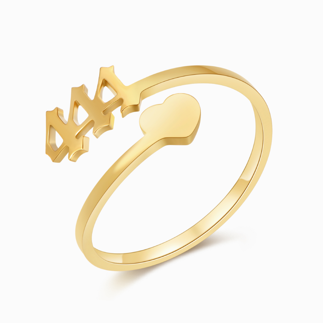 A gold ring with angel number 444 and a heart symbol on a white background