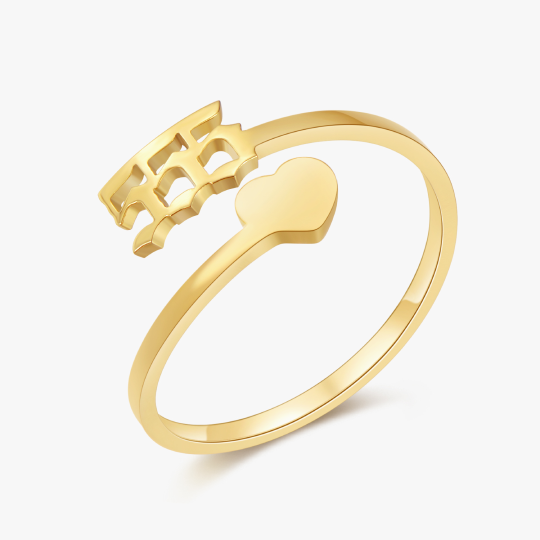 A gold ring with angel number 555 and a heart symbol on a white background