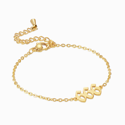 Gold bracelet with angel number 666 on white background