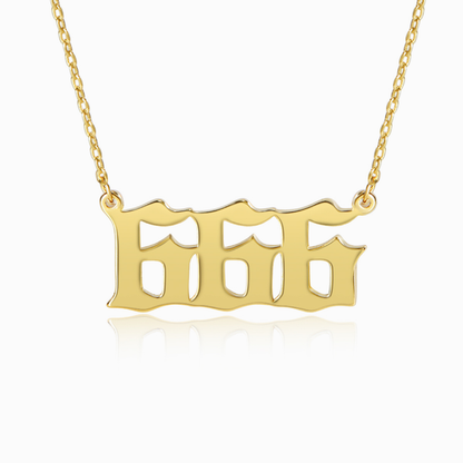 Gold chain and gold angel number 666 pendant on white background