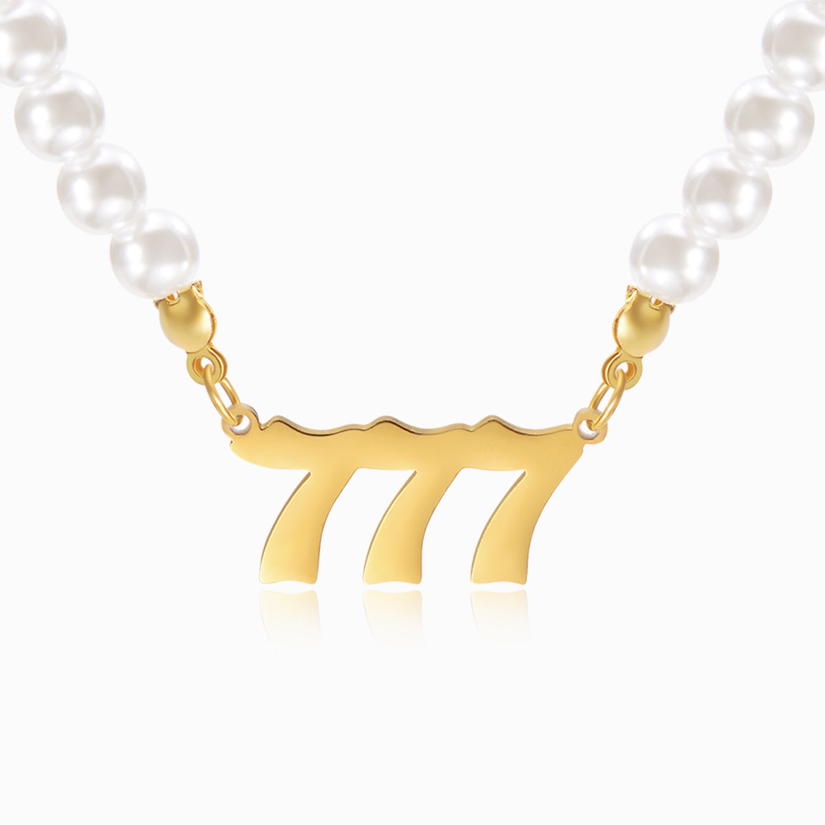 Pearl chain necklace and gold angel number 777 on white background