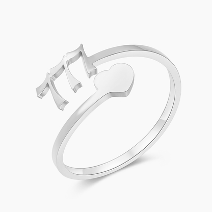 A silver ring with angel number 777 and heart symbol on a white background