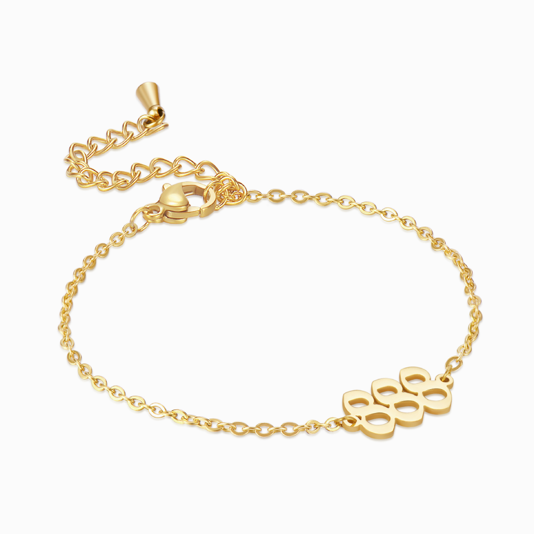 Gold chain bracelet with gold angel number 555 on white background