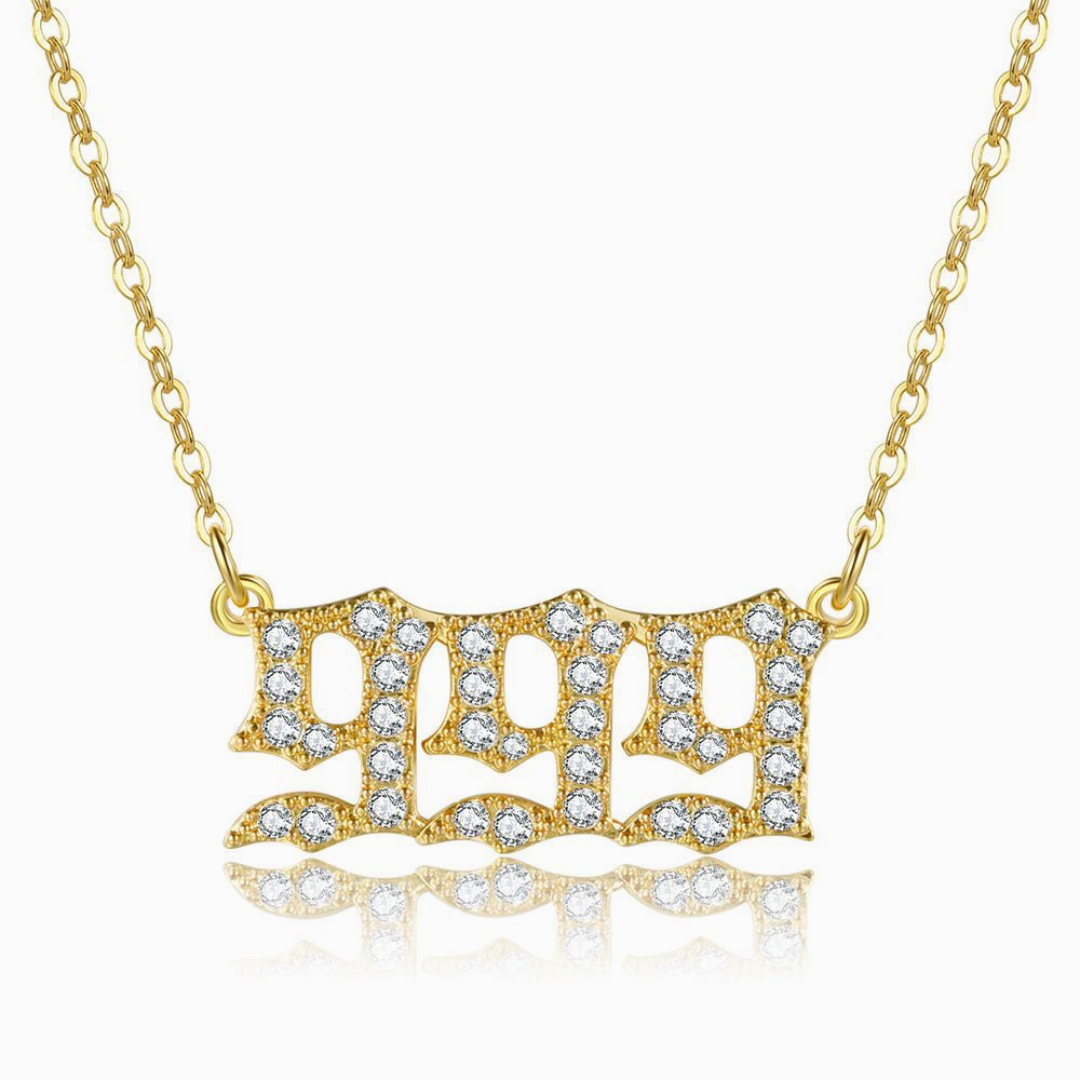 Gold chain necklace with gold angel number 999 on white background