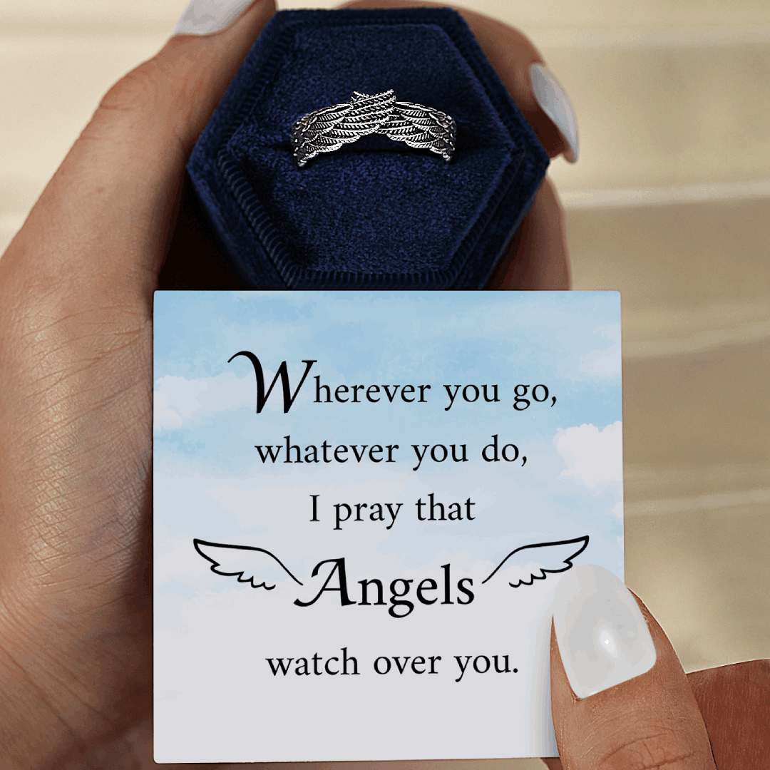 Silver wings ring on blue ring box and message card