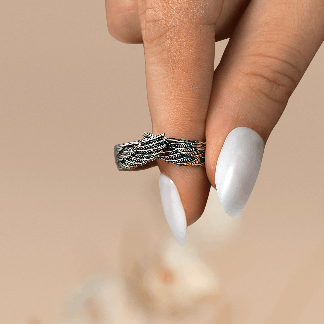 Silver wings ring on woman's fingers