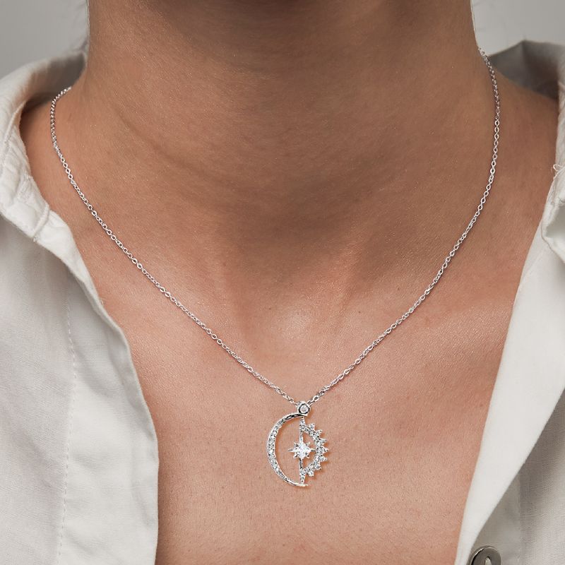 Silver necklace with celestial design pendant worn by a young woman