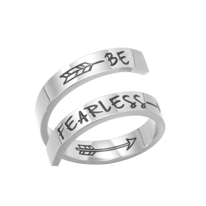 A silver twisted ring with text engraving on white background