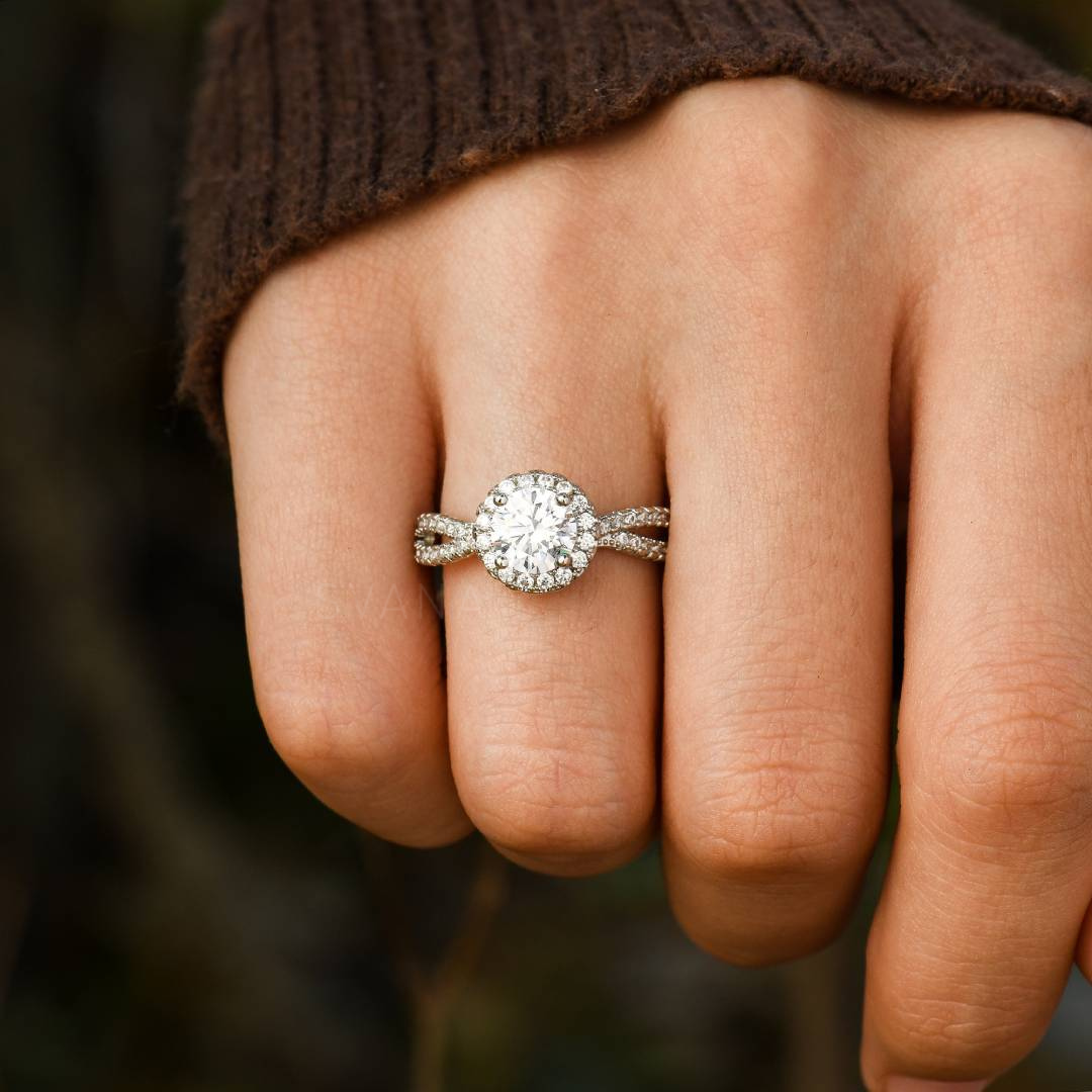 Silver ring with white stones on a woman's ring finger