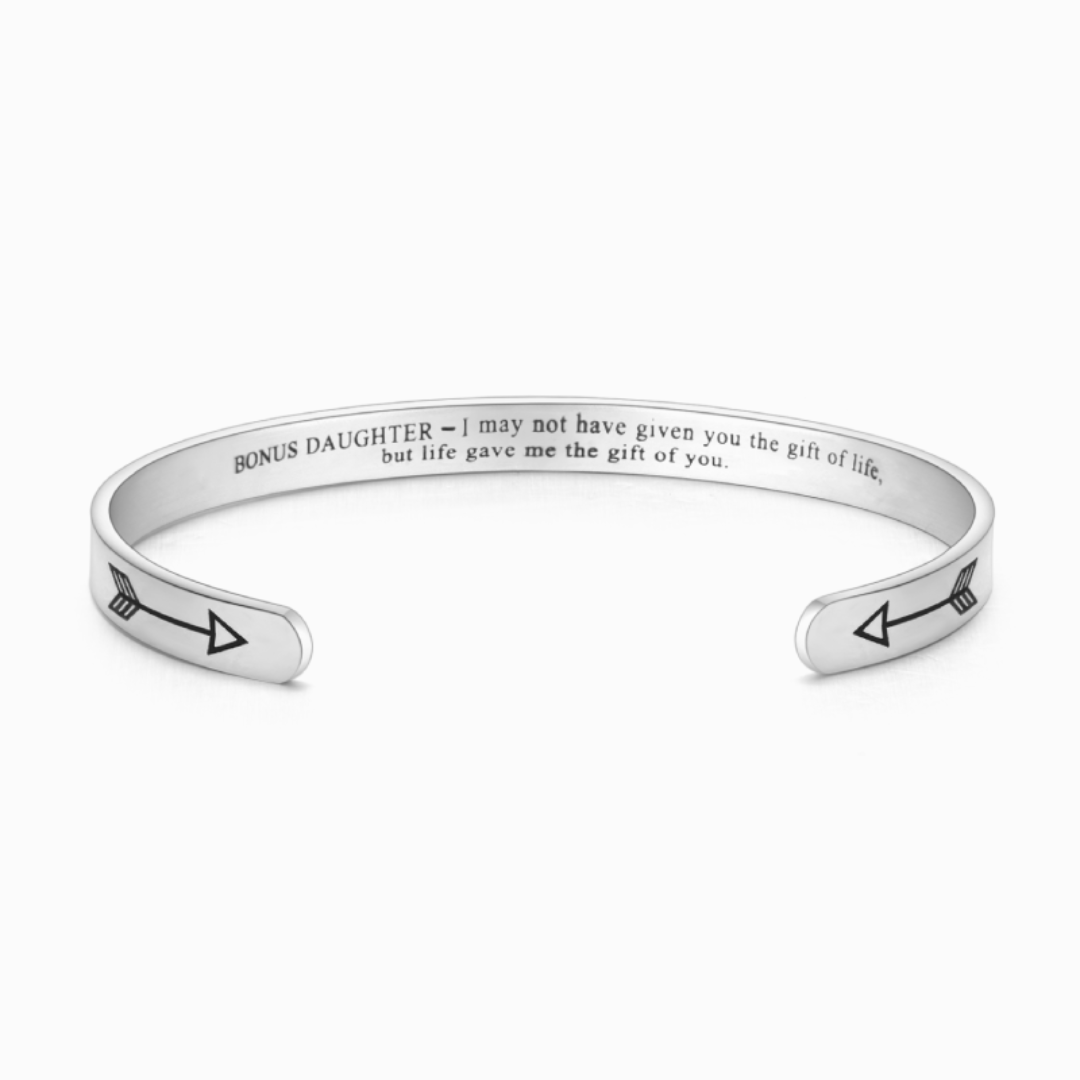 Silver bracelet engraved with text on white background