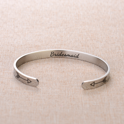 Silver bracelet with text engraving on plain canvas