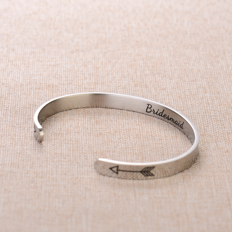 Silver bracelet with text engraving on plain canvas