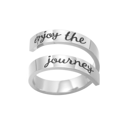 Silver twisted ring with text engraving on white background