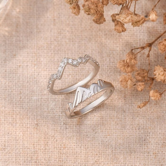 silver mountain rings with small stones on a floral background