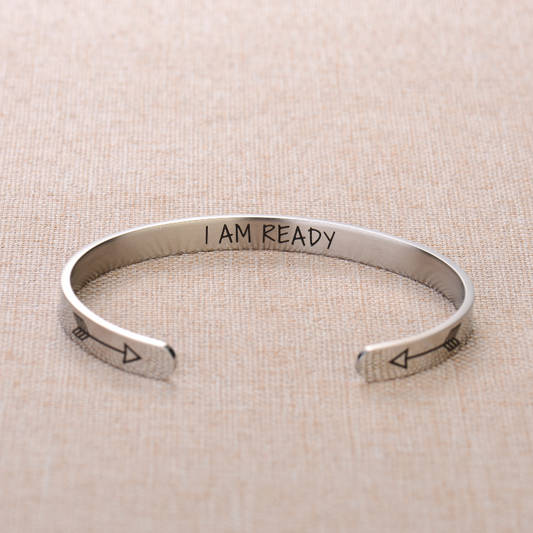 Silver bracelet with text engraving on plain canvas