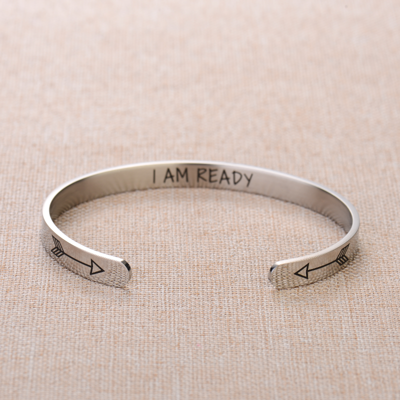 Silver bracelet with text engraving on plain canvas