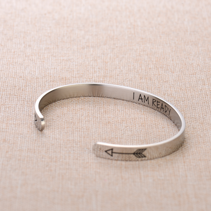 Silver bracelet with text engraving on plain canvas