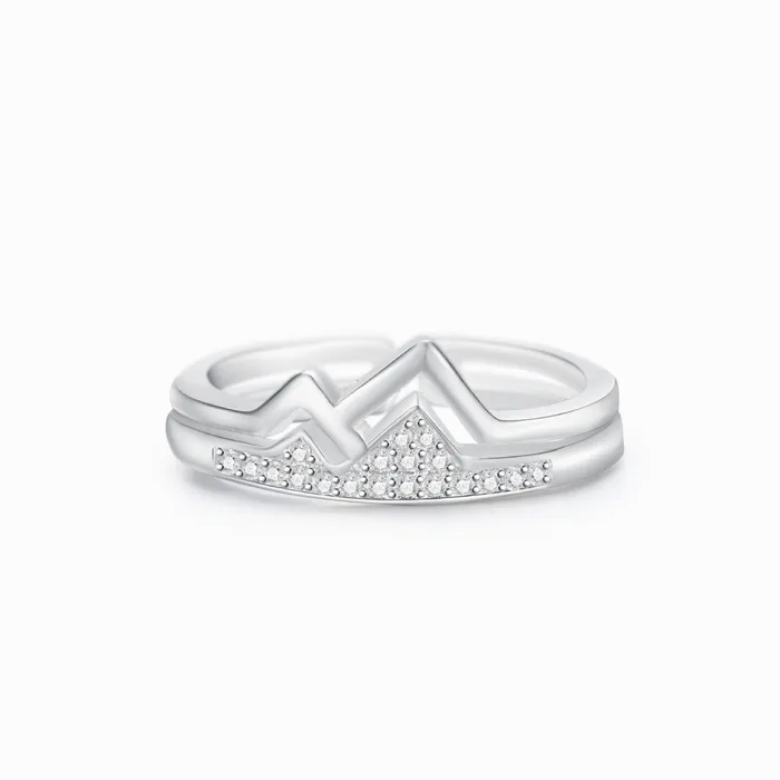 A silver mountain ring with stones on a white background