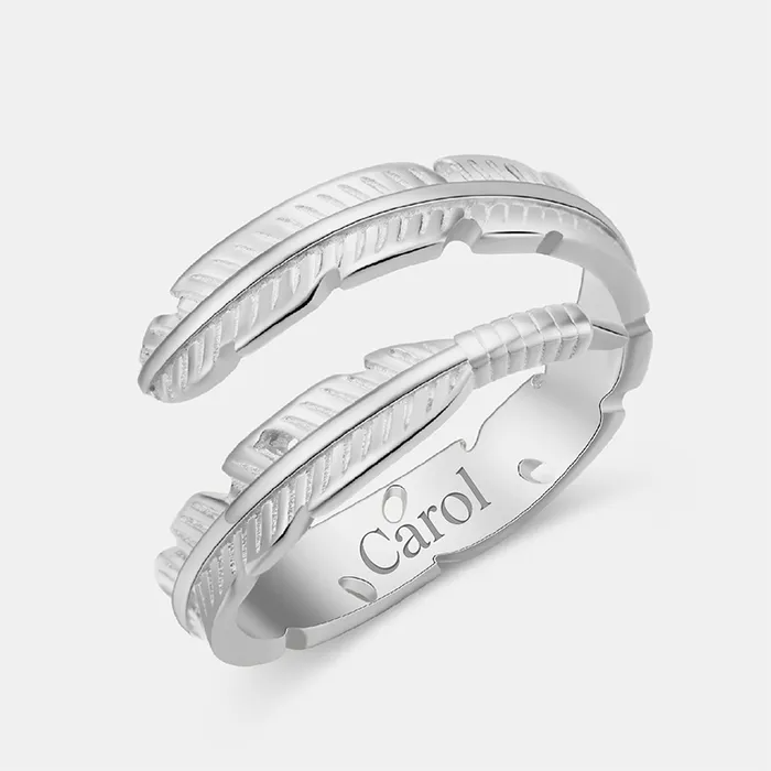 Silver feather-designed ring featuring an engraved name "Carol" on a white background.