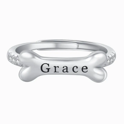 A silver dog bone ring design with personalized name on "Emma" on a white background.