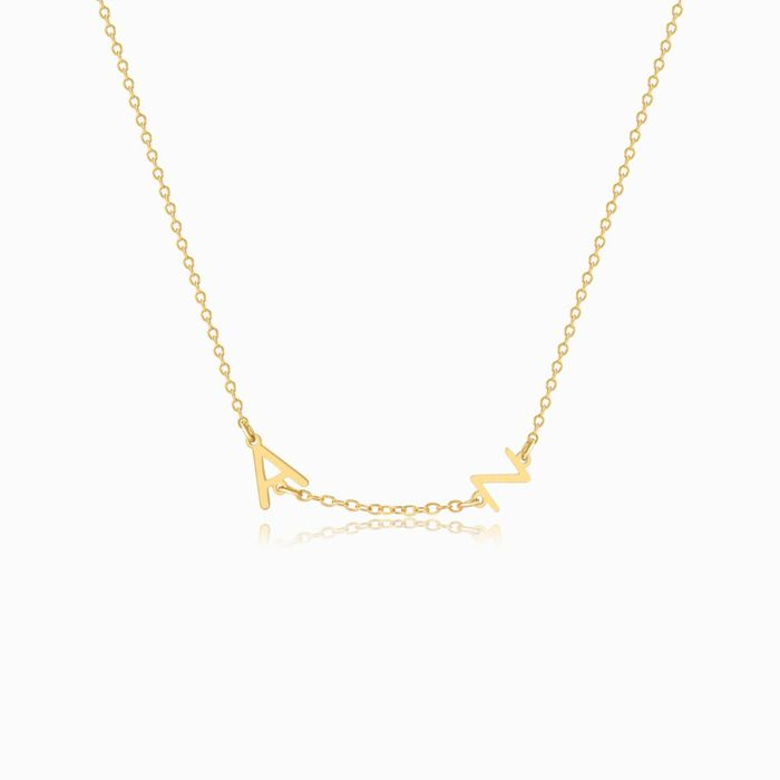 A gold personalized letter necklace with two letters on a white background