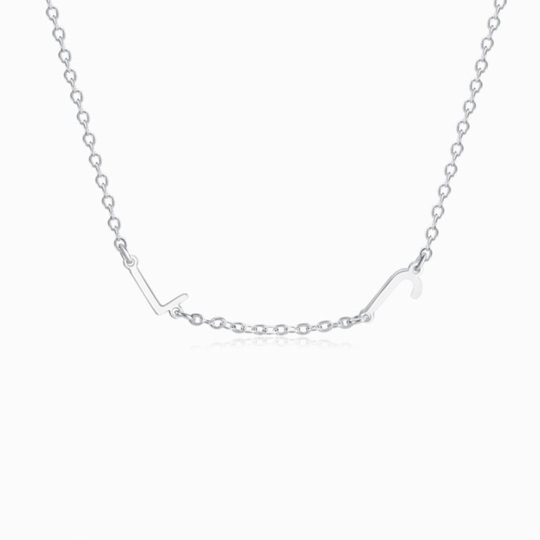 A silver personalized letter necklace with two letters on a white background