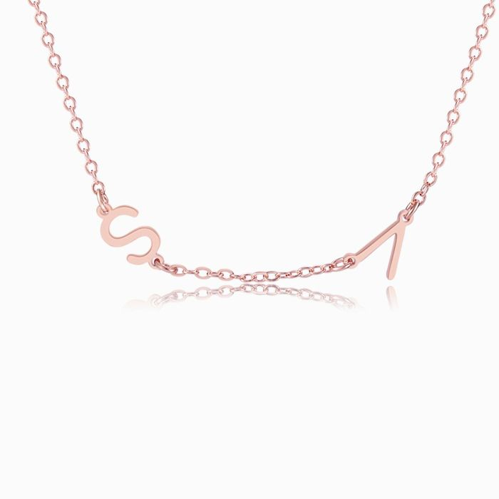 A rose gold personalized letter necklace with two letters on a white background