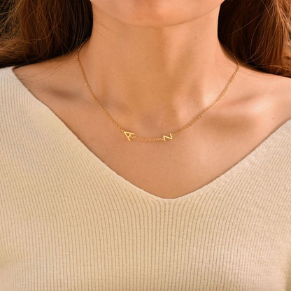 A gold personalized letter necklace on a woman's neck