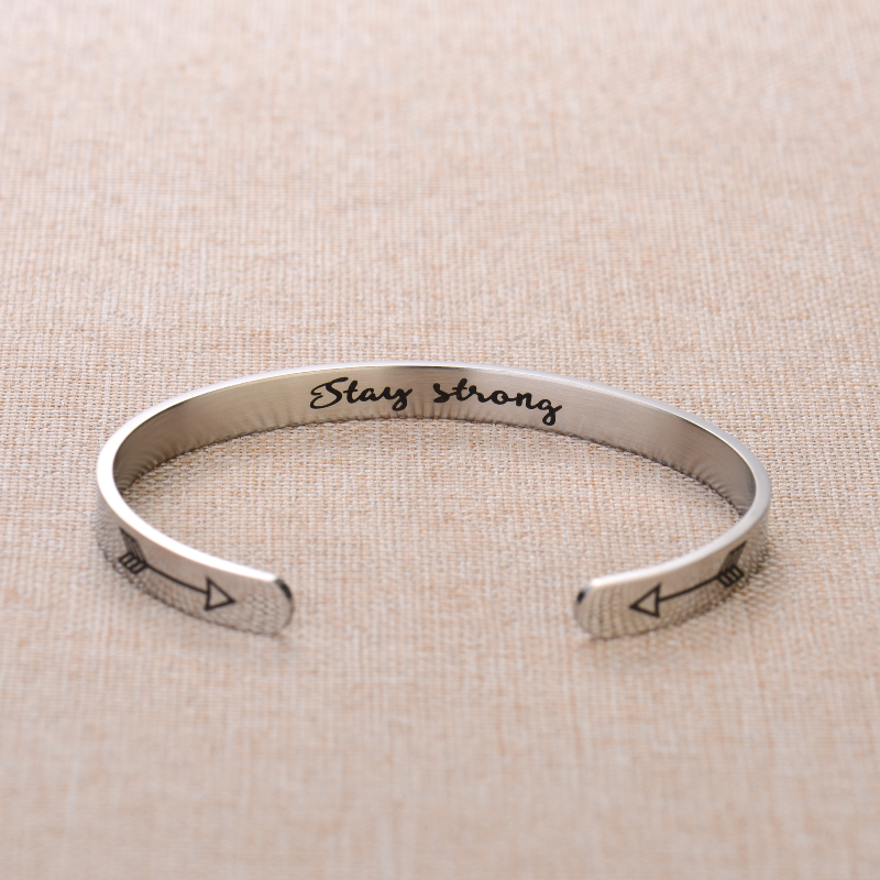 Silver bracelet with text engraving on plain canvas