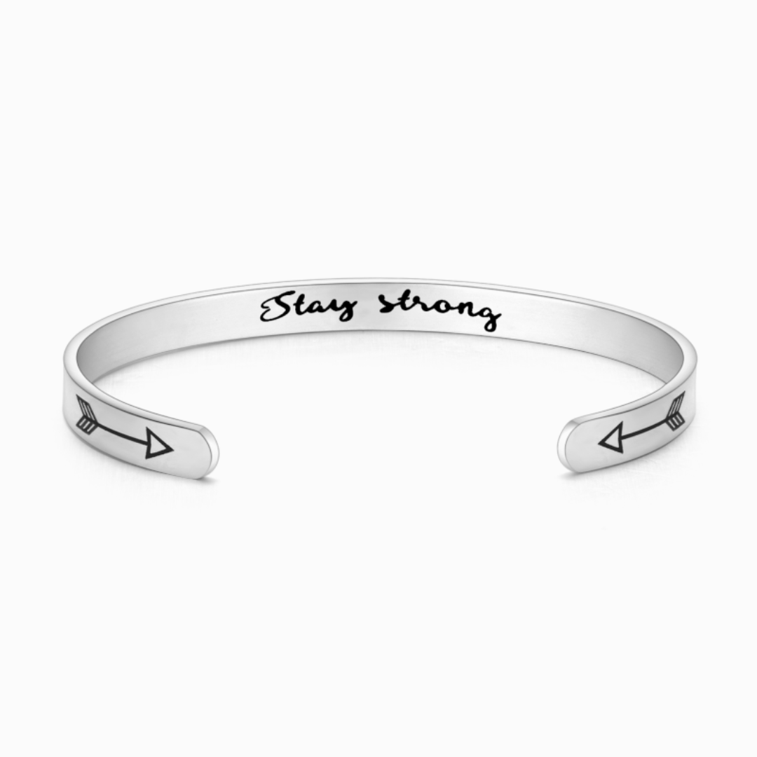 Silver bracelet with text engraving on white background