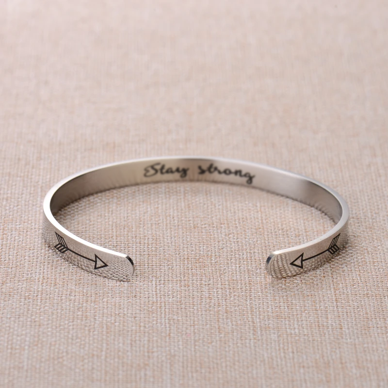 Silver bracelet with text engraving on plain canvas