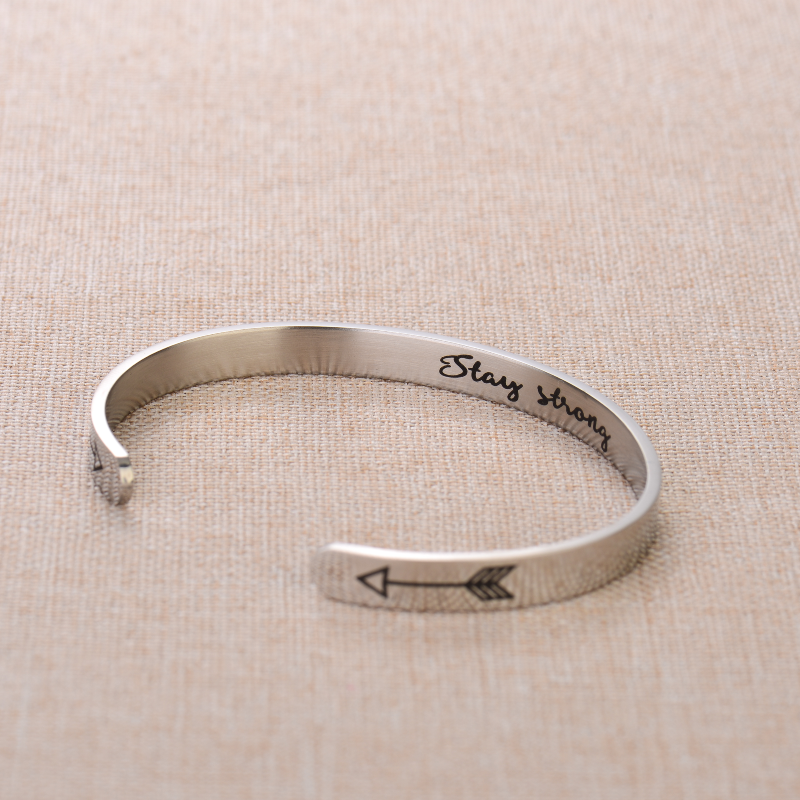 Silver bracelet with text engraving on plain canvas