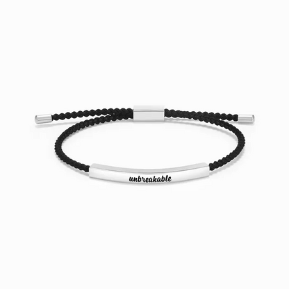 black rope with silver bar with "unbreakable" text engraving on a white background