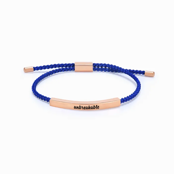 blue rope with rose gold bar with "unbreakable" text engraving on a white background