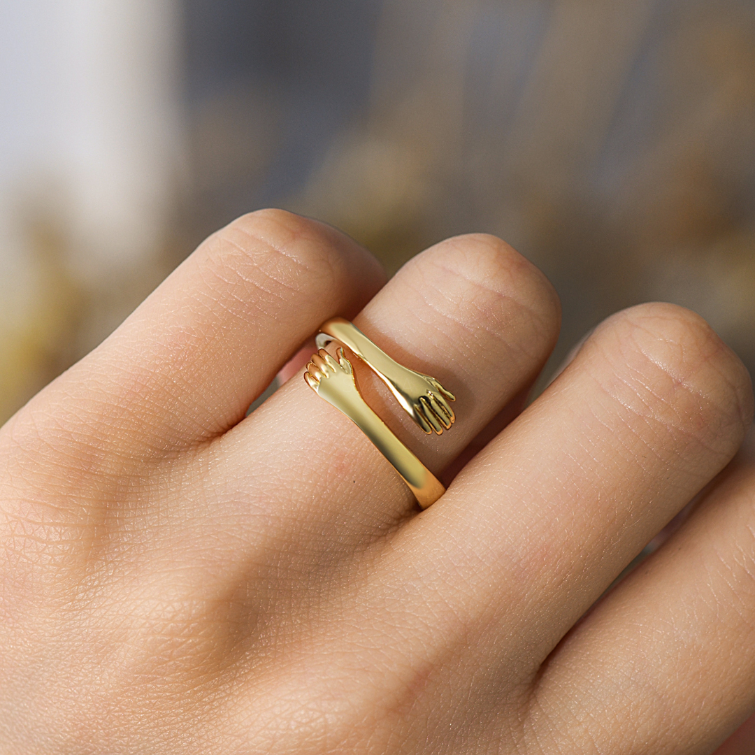 gold hug ring worn on a ring finger